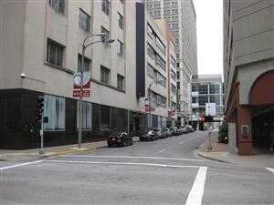 The intersection of Broadway and Locust in St. Louis showing the old St. Louis Mercantile Library on the left and the William T. Sherman marker on the right